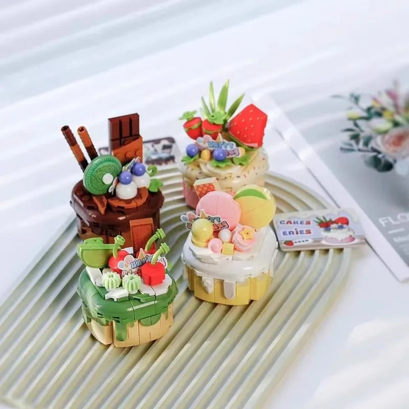 Delight in these miniature novelty cakes, intricately designed with vibrant, edible decorations that mimic a picnic basket theme, creating a whimsical dessert experience perfect for any sweet celebration. #MiniCakes #DessertArt #PicnicBasketTheme