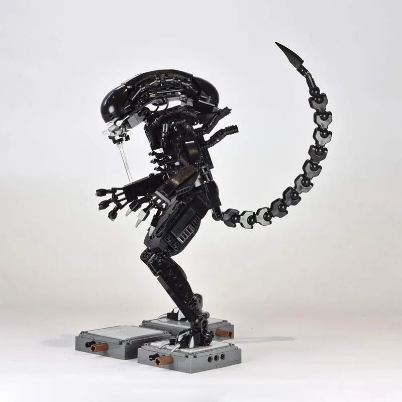 An intricate robotic sculpture with a sleek, curved design and a long, articulated tail, poised on a metal base, showcasing mechanical elegance and futuristic creativity.